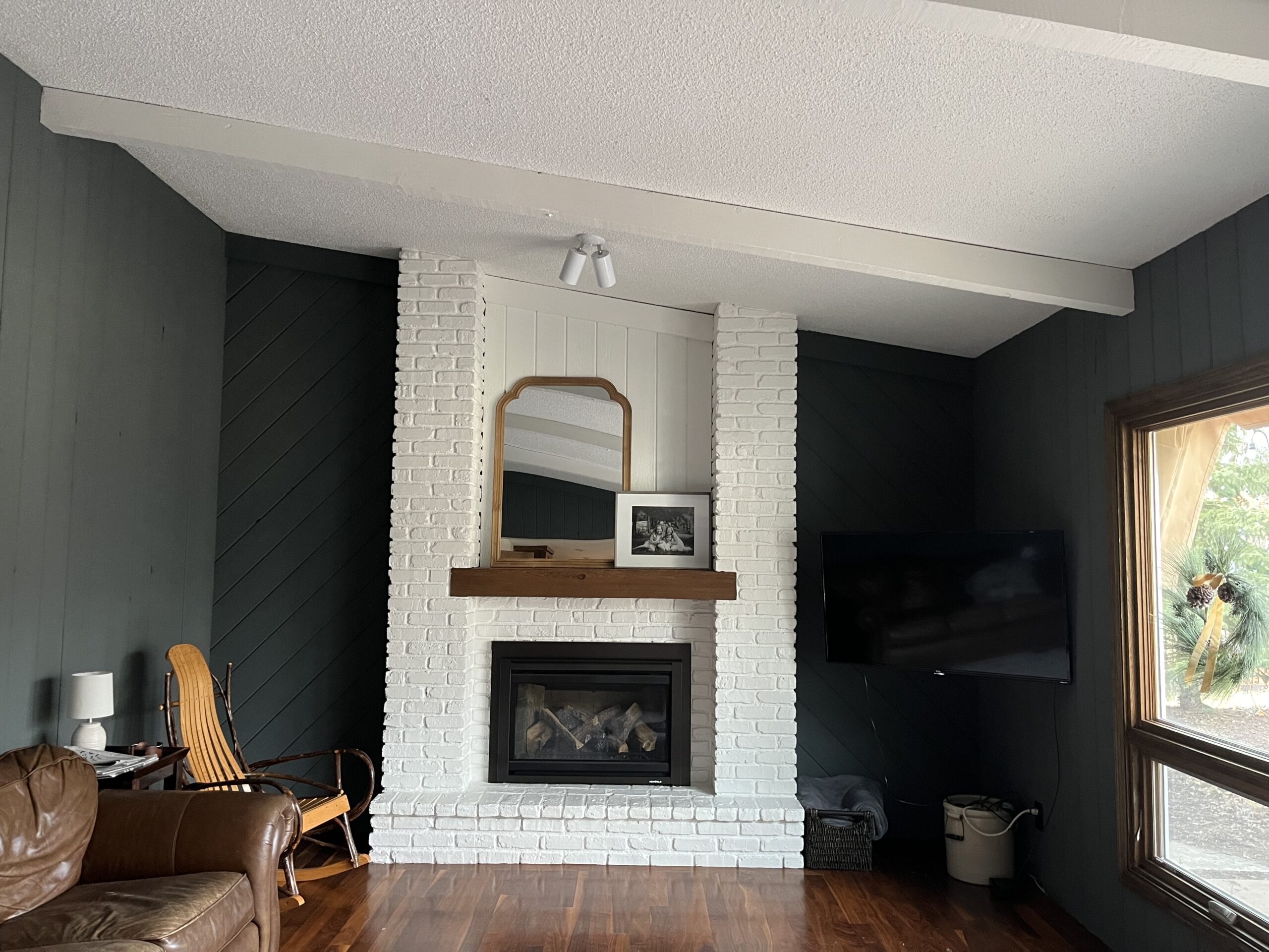 Moody living room with white brick fireplace