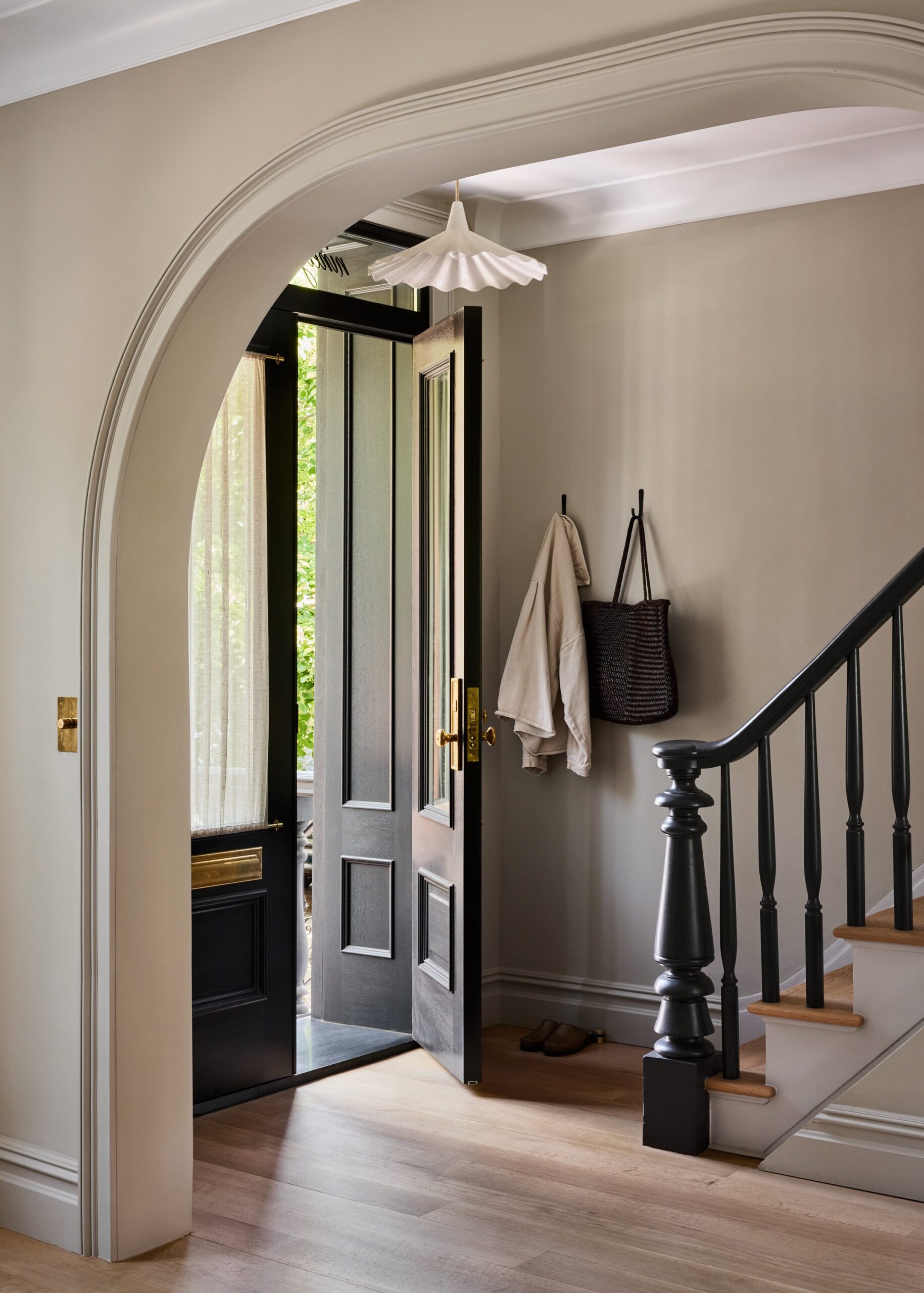 Traditional entryway with a black railing