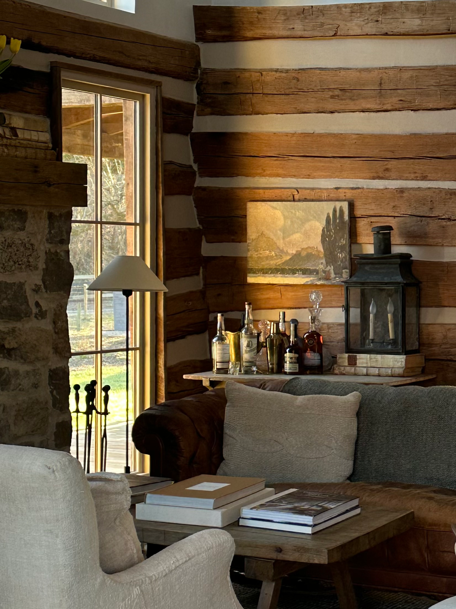 Rustic cabin living room with log walls and chinking. Home by Velvet and Linen