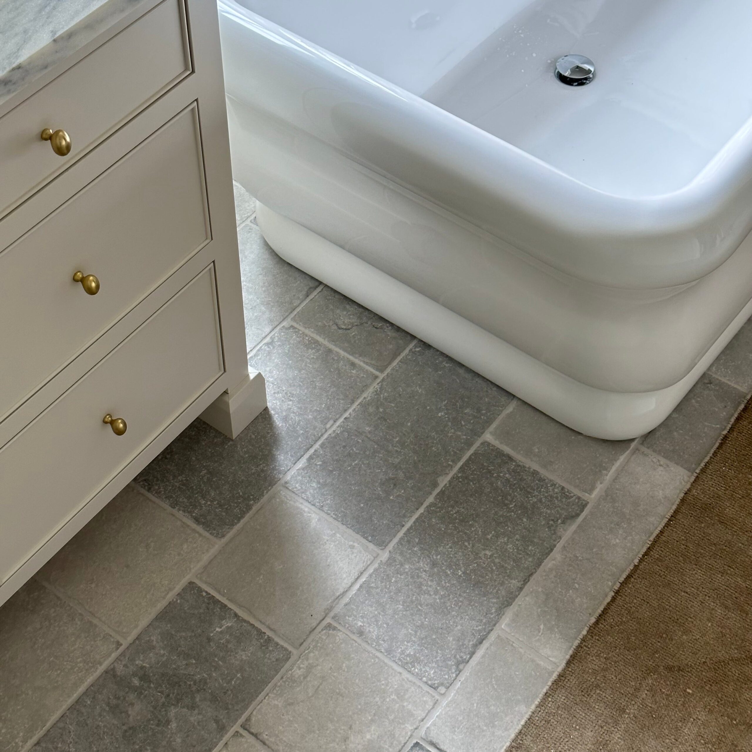 Affordable stone tile lookalikes. The best stone tile alternatives. Bathroom limestone floor tile lookalike. Design by W Design Collective.