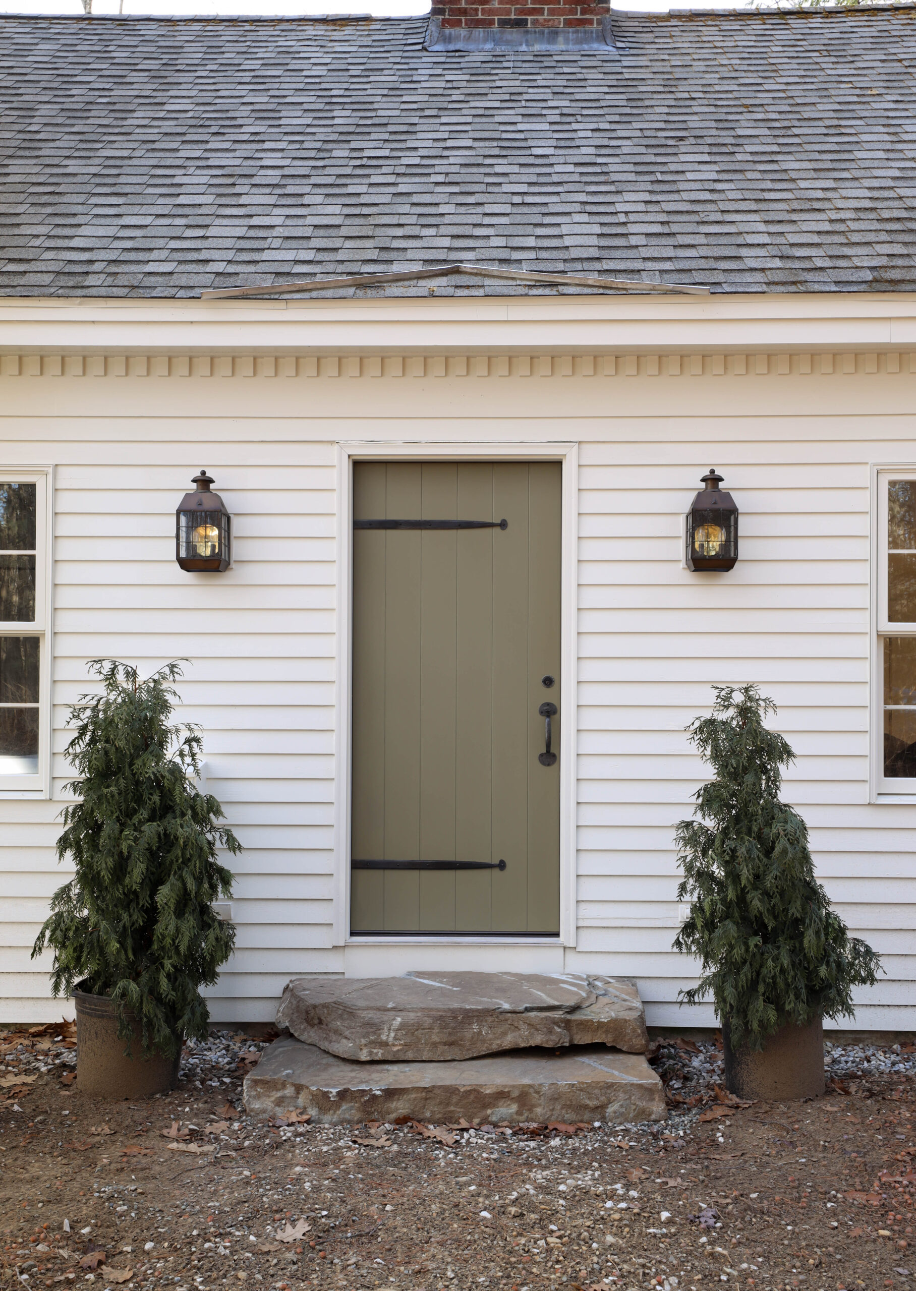 Olive avocado green paint color on front door. Wood plank front door on historic Cape Cod home. Iron strap hinges. Iron thumb latch handle. Nadine Stay