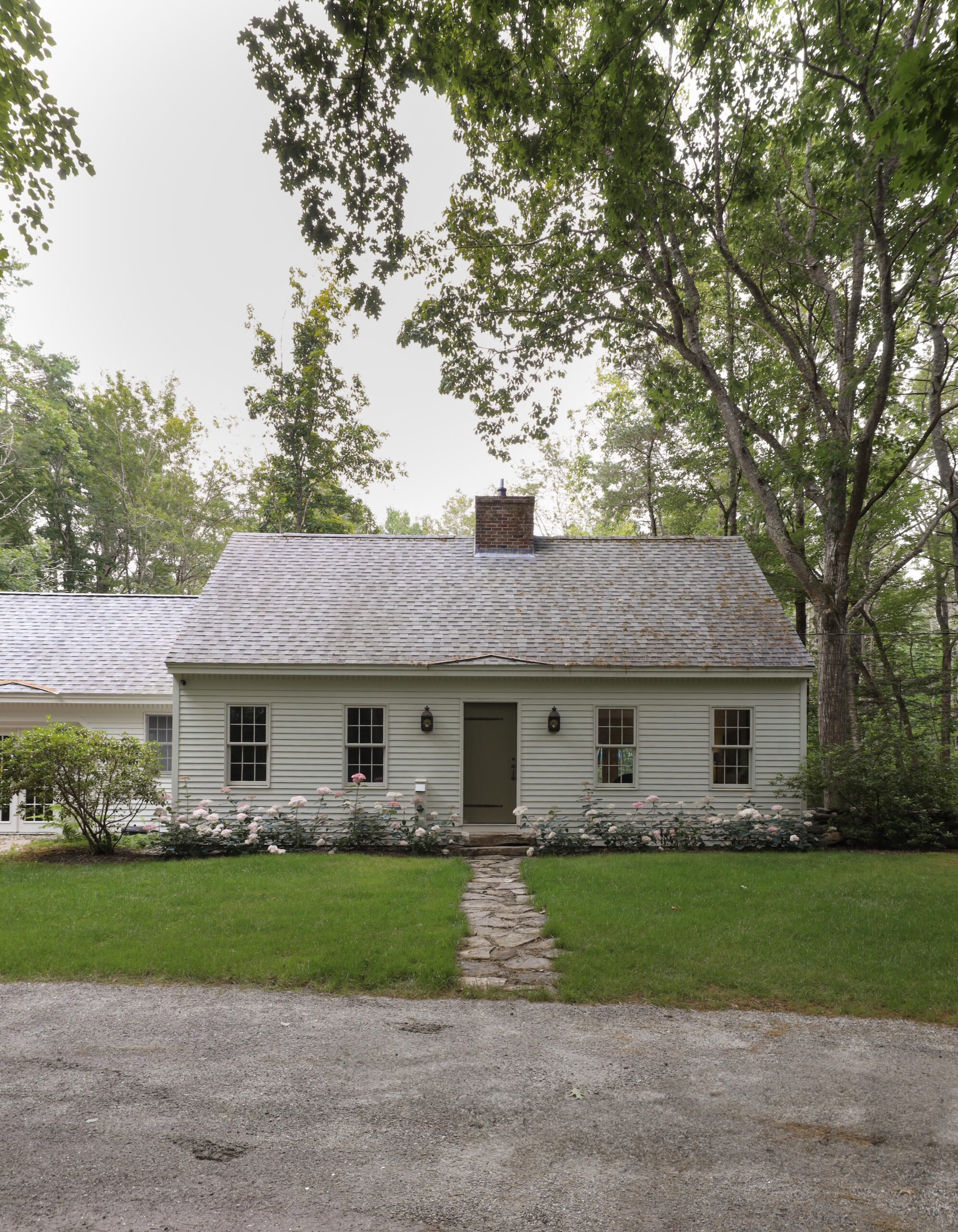 New England Cape Cod home exterior by Nadine Stay. Oyster White by Sherwin Williams