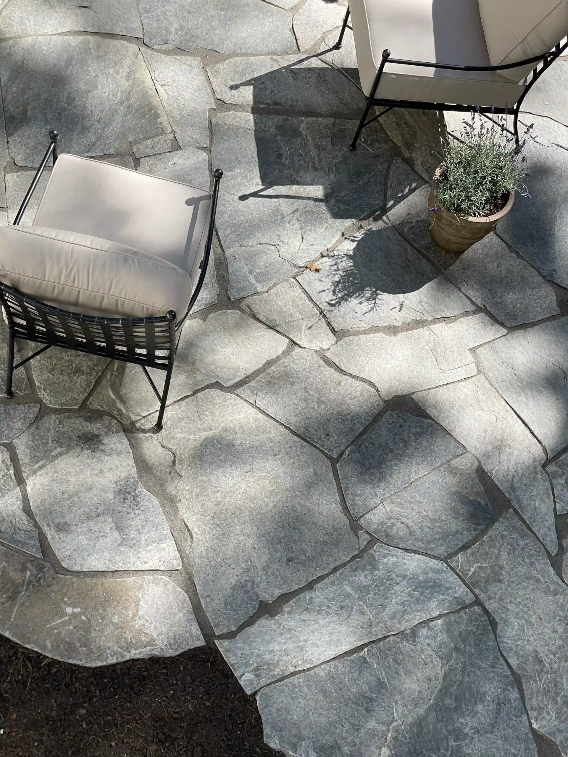 Flagstone patio with polymeric sand and patio chairs