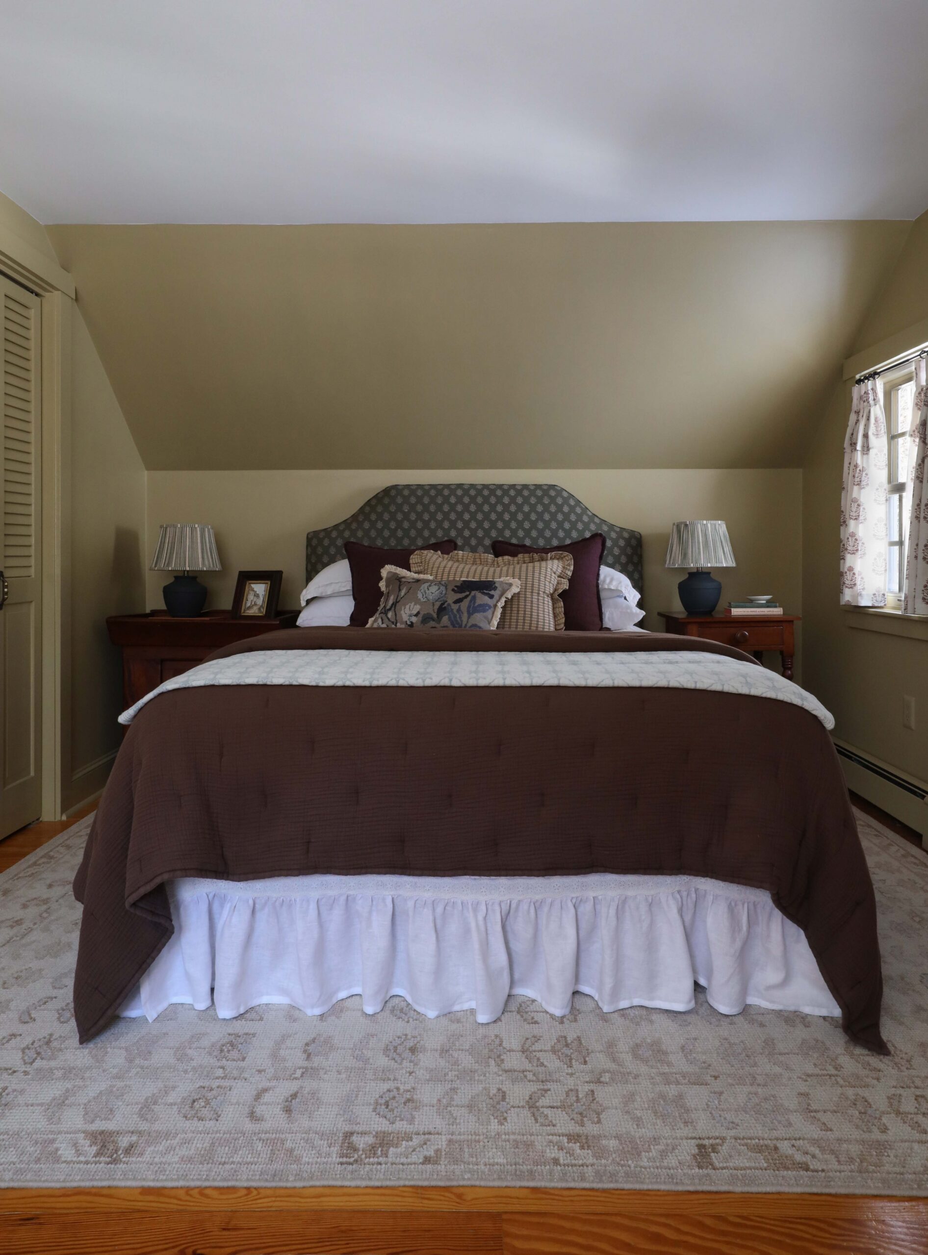 Moody green yellow bedroom with mismatched nightstands - Nadine Stay