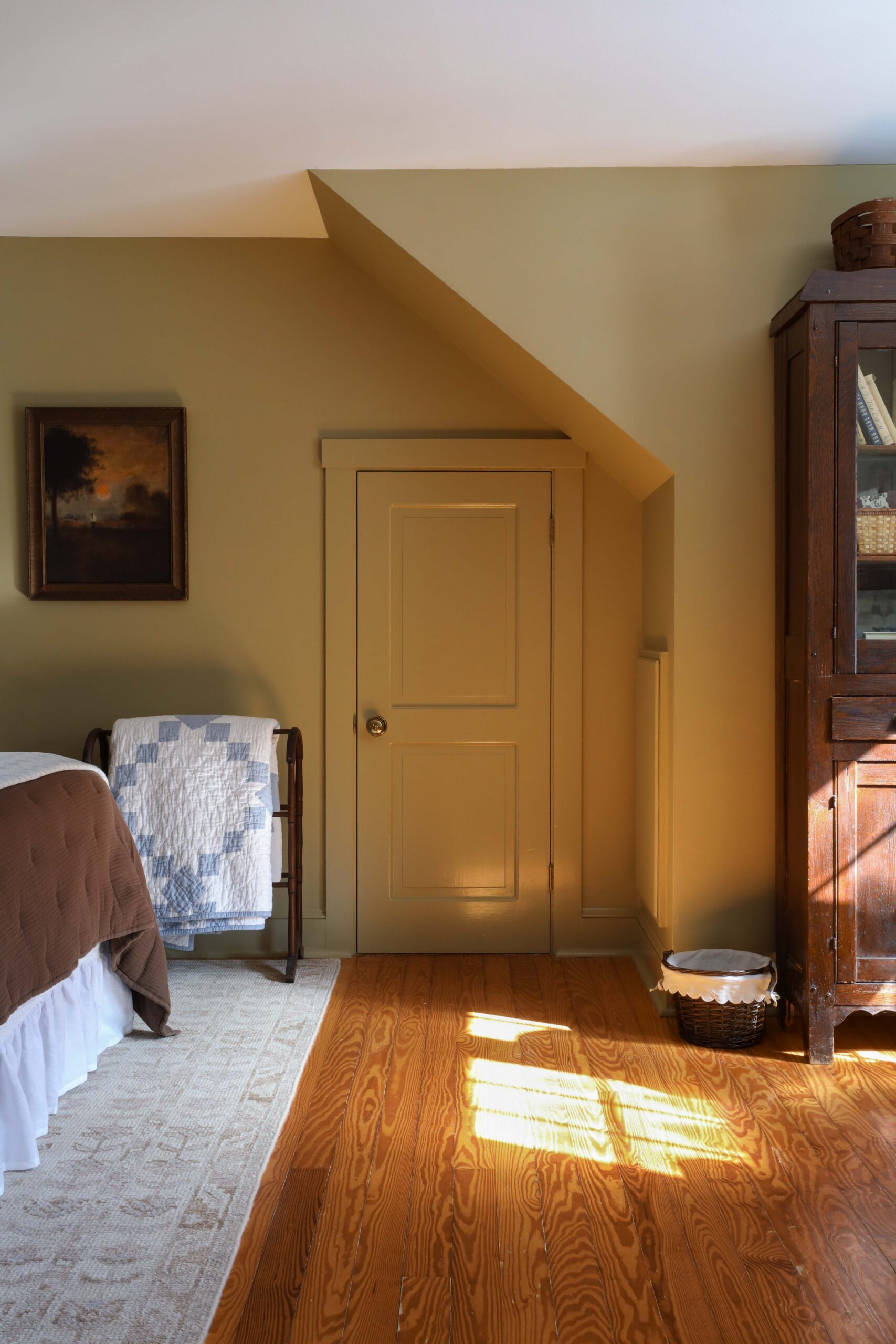Small door with wheat colored walls in bedroom - Nadine Stay