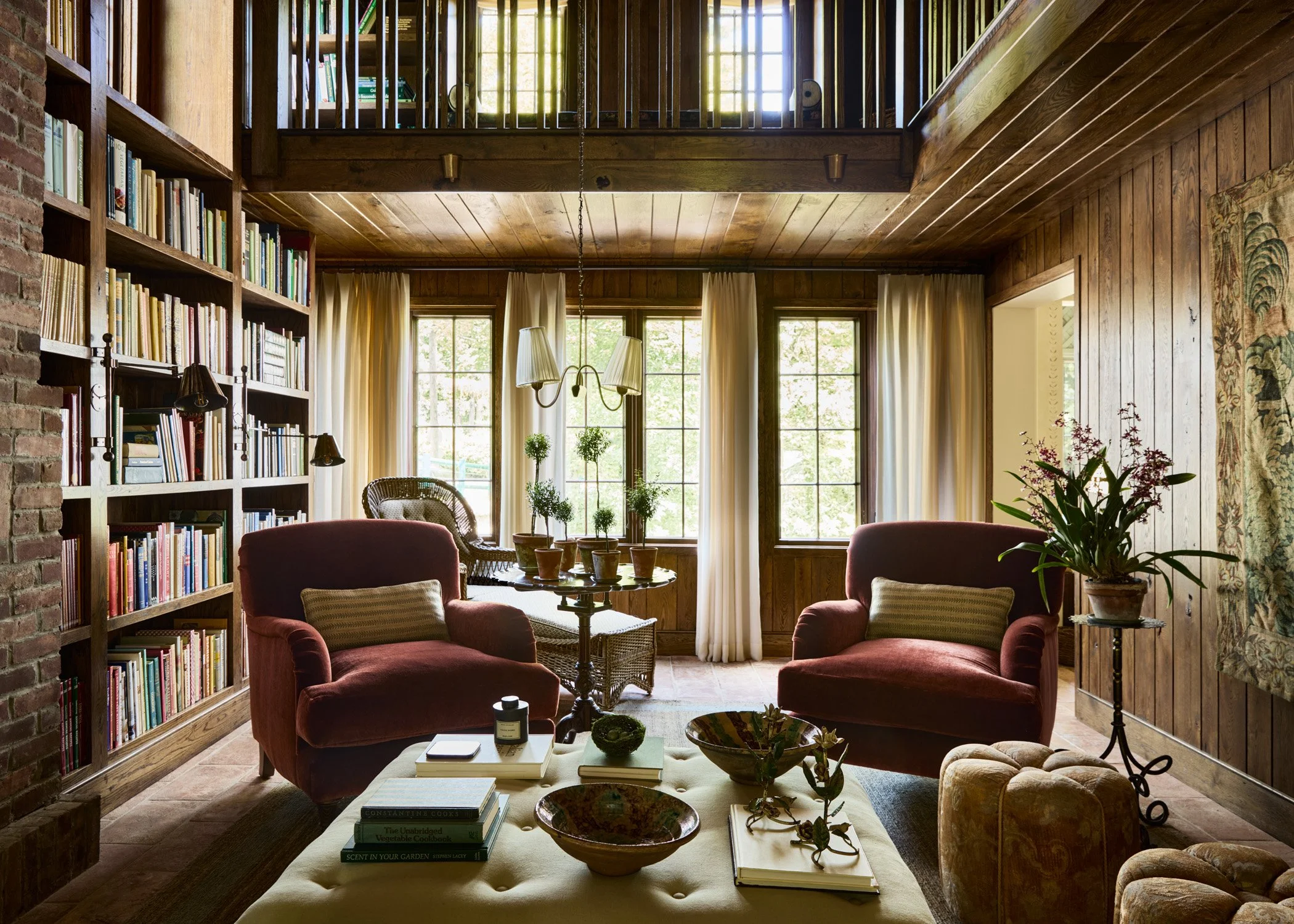 Library with tailor pleated curtains and English roll arm chairs. Moore House Design