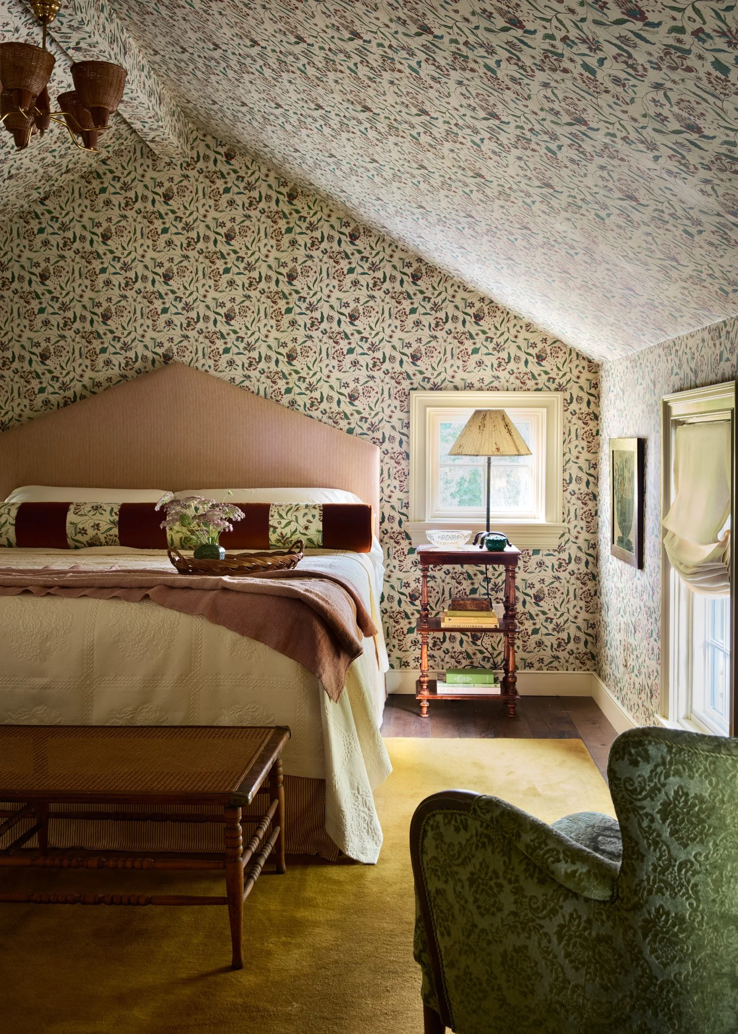 Bedroom with floral wallpaper and striped headboard and bed skirt. Design by Moore House Design