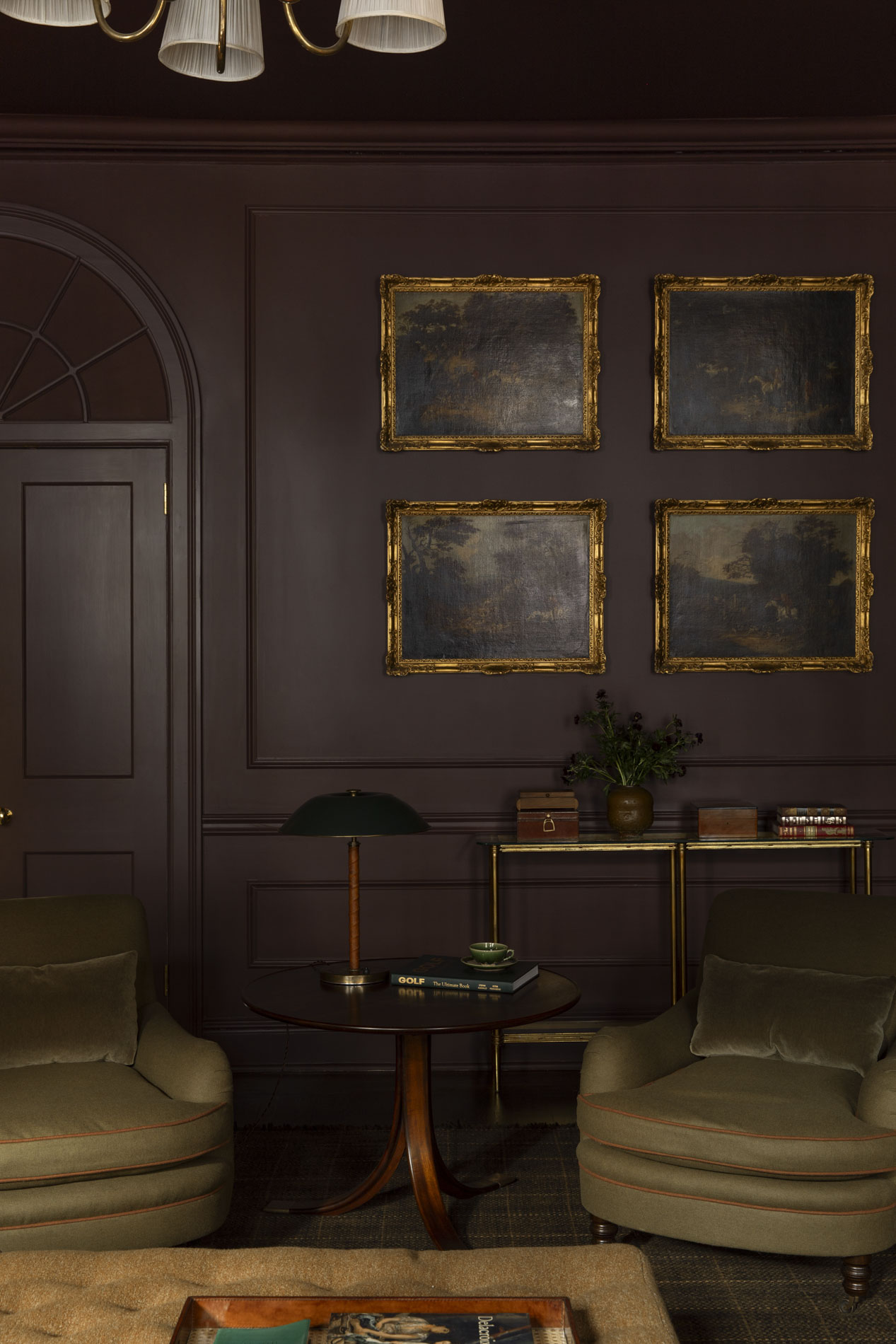 Study with plum paneling, antique paintings, and green chairs. Hadley Wiggins and Malcolm Brown